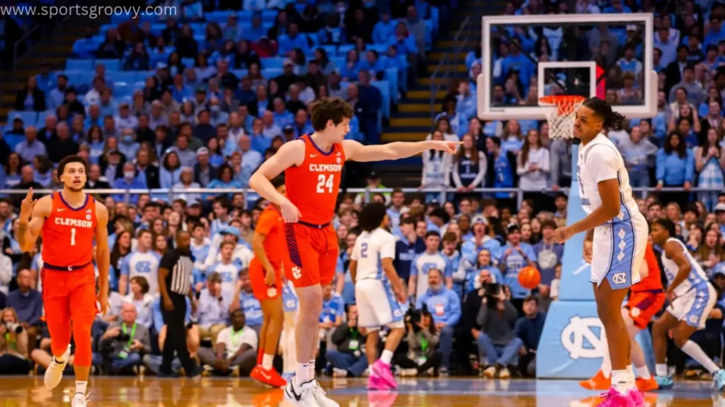 Clemson basketball player making a sign for winning after make a goal.