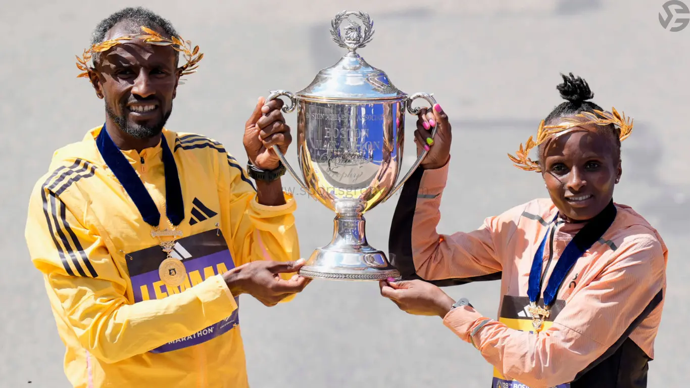 Boston Marathon men's division winner Sisay Lemma, of Ethiopia, and women's division winner Hellen Obiri, of Kenya hold up the trophy at the Boston Marathon on April 15, 2024.