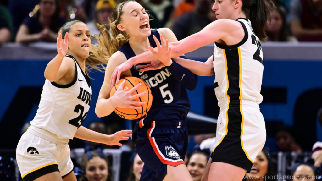  Caitlin Clark #22 of the Iowa Hawkeyes reaches for the ball as Paige Bueckers #5 of the UConn Huskies reacts in the second half during the NCAA Women's Basketball Tournament Final Four semifinal game at Rocket Mortgage Fieldhouse on April 05, 2024 in Cleveland, Ohio.