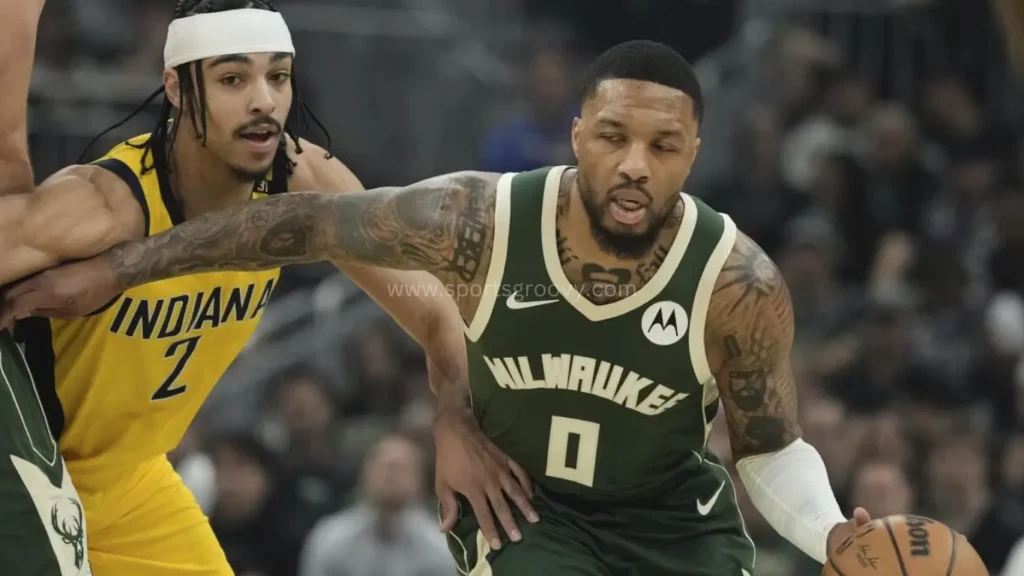 Milwaukee Bucks’ Damian Lillard grabs a rebound in front of Indiana Pacers’ Tyrese Haliburton during the second half of Game 1 of the first round NBA playoff basketball.