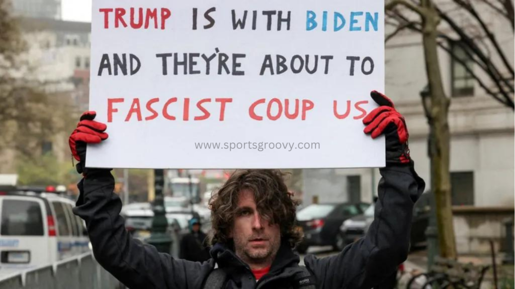 Maxwell Azzarello holds a sign outside the Manhattan court on Thursday.