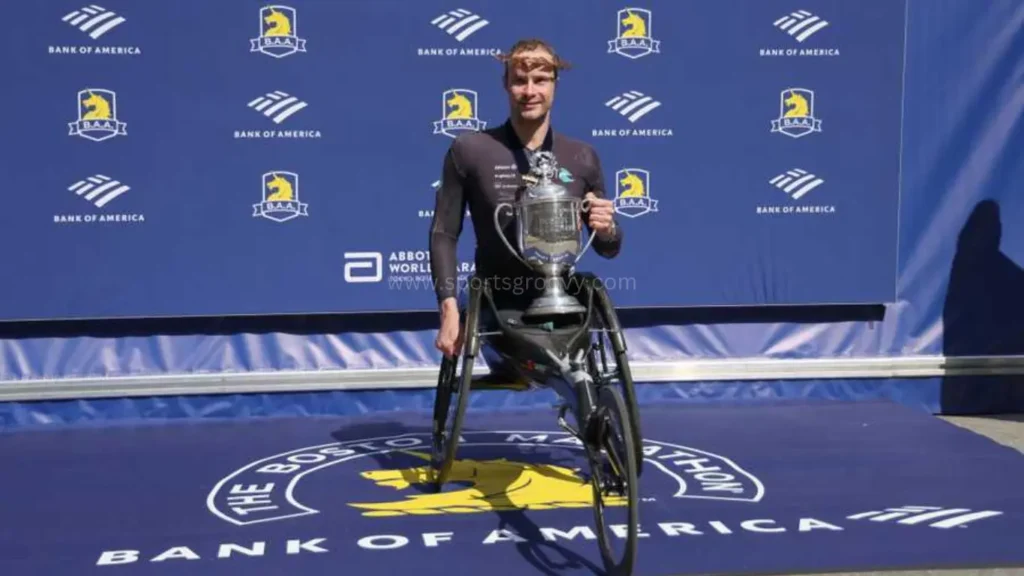 Marcel Hug, of Switzerland, breaks the tape to win the men's wheelchair division of the Boston Marathon on April 15, 2024.