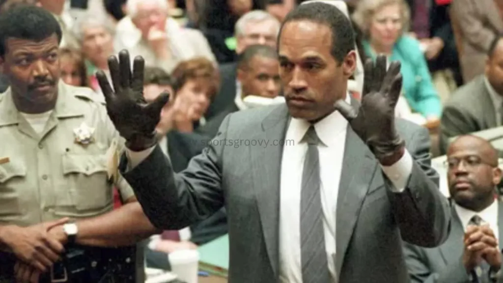 In this June 21, 1995 file photo, O.J. Simpson holds up his hands before the jury after putting on a new pair of gloves similar to the infamous bloody gloves during his double-murder trial in Los Angeles.