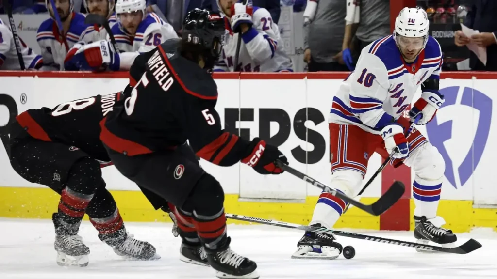 Artemi Panarin (10) loses control of the puck to Hurricanes’ Jordan Martinook (48) and Jalen Chatfield (5) during the third period of the Rangers’ Game 4 loss.