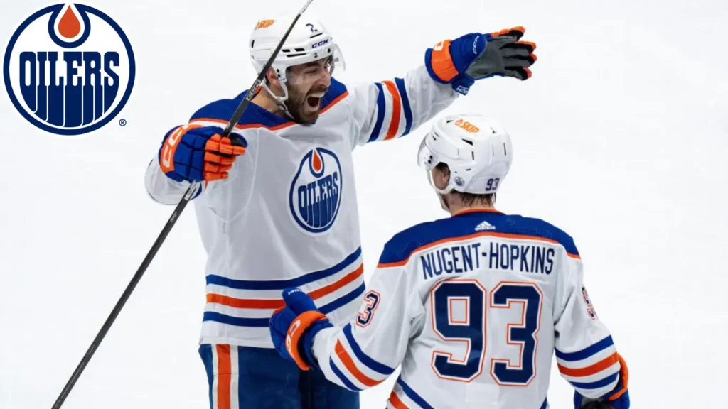 Evan Bouchard (2) and Ryan Nugent-Hopkins (93) of the Edmonton Oilers celebrate after assisting on Zach Hyman’s goal against the Vancouver Canucks in Game 7 of the NHL Stanley Cup second-round playoff series in Vancouver, British Columbia, on Monday, May 20, 2024.