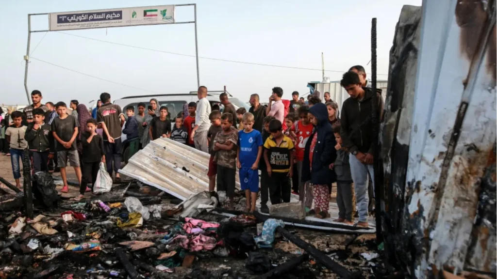 Palestinians survey the devastation in Rafah, Gaza Strip, following an Israeli airstrike on Monday, May 27, 2024.