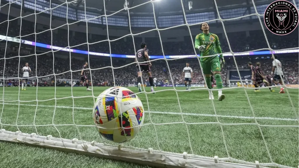 In this MLS match, Vancouver Whitecaps goalkeeper Yohei Takaoka, positioned front and right, watches the ball nestle in the back of the net following a goal scored by Inter Miami's Robert Taylor during the first half.