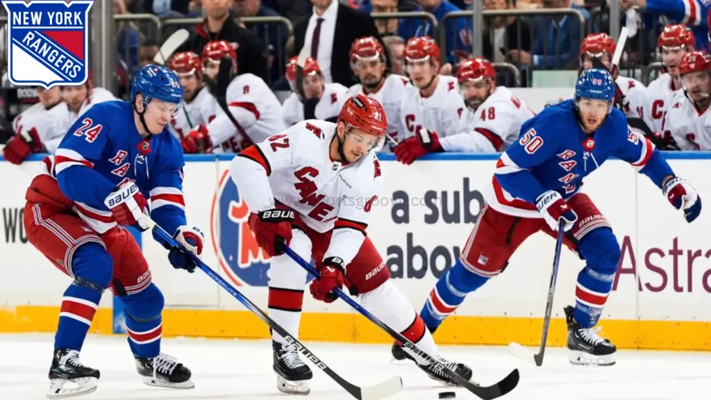 New York Rangers right wing Kaapo Kakko (24), left wing Will Cuylle (50) and Carolina Hurricanes center Jesperi Kotkaniemi (82) fight for the puck during the first period in Game 2 of an NHL hockey Stanley Cup second-round playoff series, Tuesday, May 7, 2024, in New York.