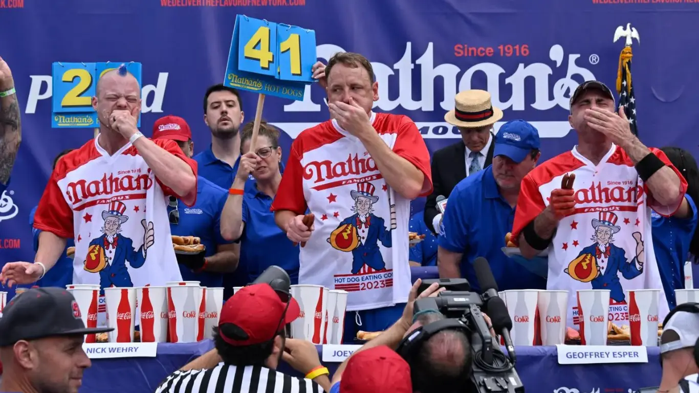 Joey Chestnut, as seen in last year’s competition, has triumphed at Nathan’s a total of 16 times, consecutively winning every year since 2016.