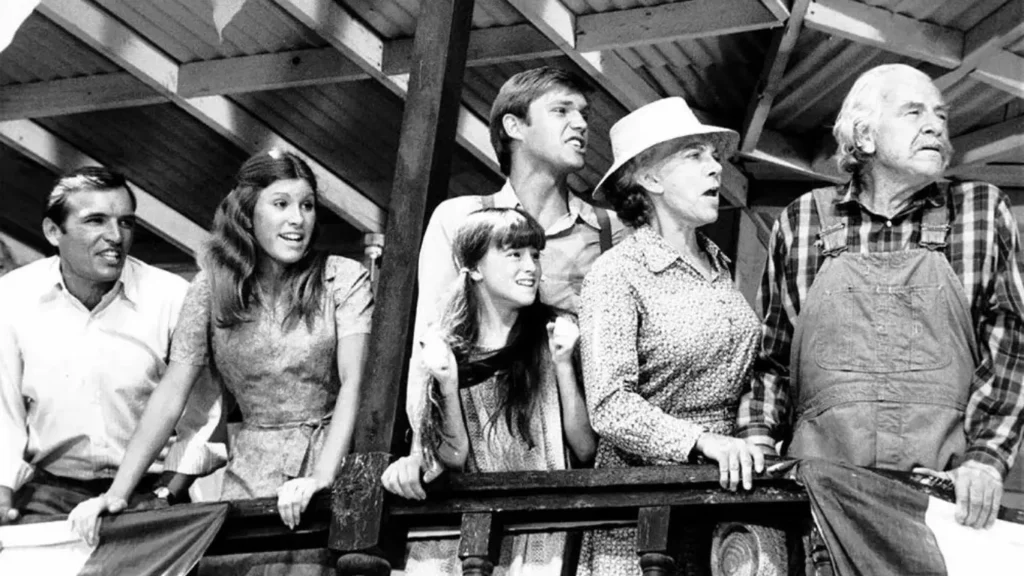 In this 1977 photo from "The Waltons," we see Tom Bower, Judy Norton, Richard Thomas, Kami Cotler, Ellen Corby, and Will Geer.