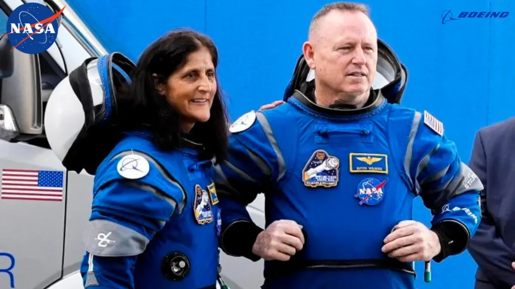 NASA astronauts Butch Wilmore (left) and Suni Williams, donning Boeing spacesuits, leave the operations and checkout building en route to the launchpad at Kennedy Space Center in Florida.