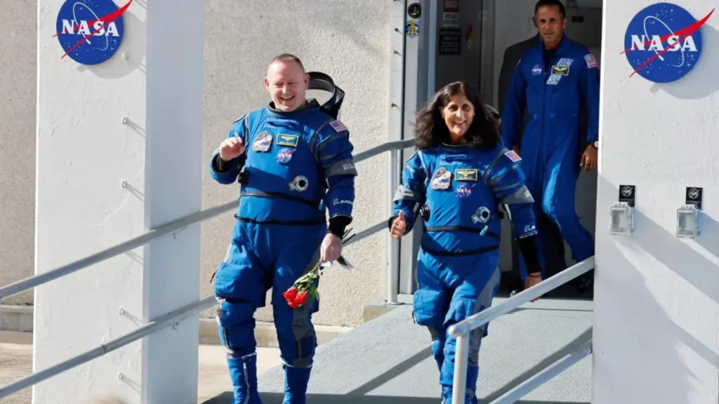 At NASA's Kennedy Space Center in Florida, astronauts Butch Wilmore (left) and Suni Williams stroll before embarking on Boeing's Starliner spacecraft for the Crew Flight Test mission.