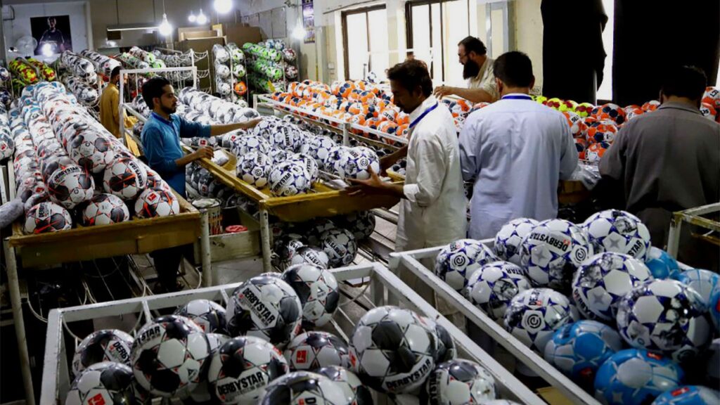 Soccer ball is being prepared in a Pakistani factory.